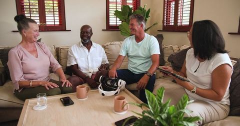 Diverse Friends Sitting Together with VR Headset and Tablet