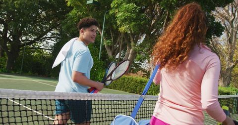 Couple Enjoying Tennis Game on Sunny Court
