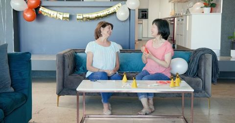 Senior Women Preparing Birthday Celebration in Living Room