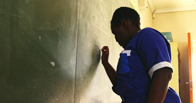 Female Student Solving Math Problem on Chalkboard in Classroom - Download Free Stock Images Pikwizard.com