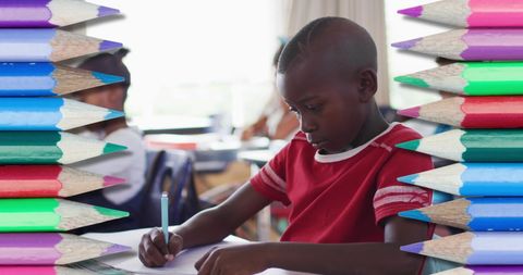 Student Concentrating on Writing Surrounded by Colorful Pencils