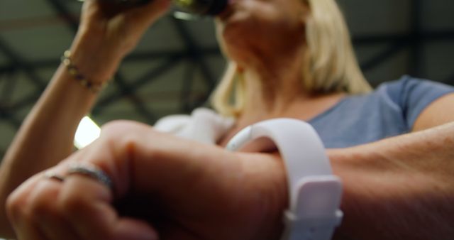 Young Woman Wearing Fitness Tracker Drinking Water During Workout - Download Free Stock Images Pikwizard.com