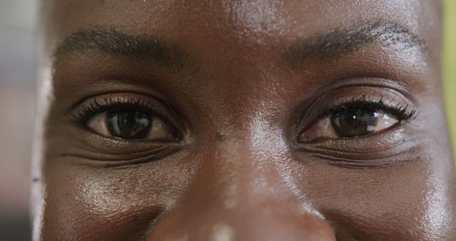 This close-up shot of a woman's eyes capturing a joyful expression. Useful for content related to emotions, happiness, human expressions, or even eye care and beauty products. The image emphasizes the authenticity of the woman's look, making it perfect for campaigns aimed at portraying genuine emotion and human connection.