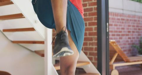 Active young man stretching indoors promotes home workout lifestyle