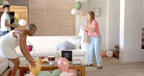 Friends decorations celebrating new job indoors