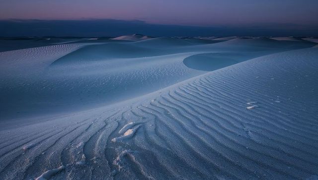 Twilight Sand Dunes Showing Wind-Sculpted Ripples and Smooth Crescent Basin