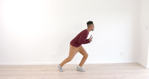 Man Dancing Energetically in Empty Bright Room