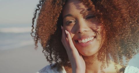 Joyful Young Woman Smiling on Sunny Beach Day