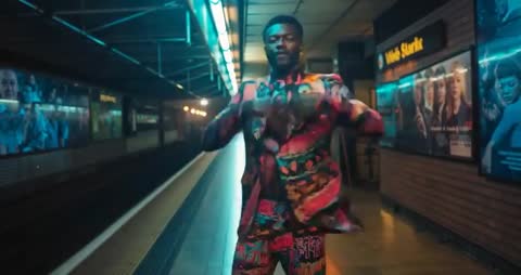 Man in Colorful Suit Energetically Dancing on Subway Platform