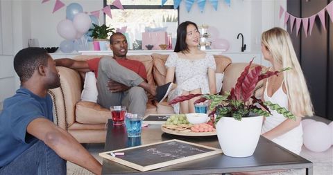 Friends Celebrating Baby Shower with Joyful Conversations