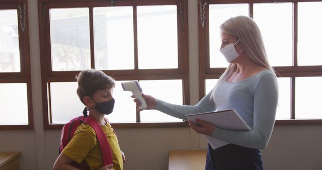 Teacher Checking Student Temperature in Classroom During Pandemic - Download Free Stock Images Pikwizard.com