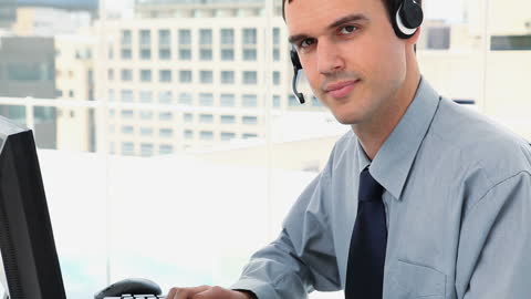 Confident Customer Service Agent with Headset Working in Modern Office