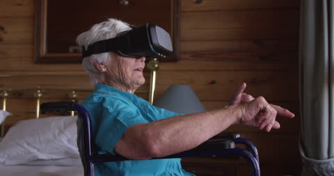 Senior Woman Experiencing Virtual Reality at Home in Wheelchair