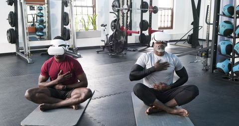 Men meditating with vr headsets in gym for modern wellness
