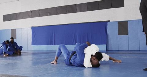 African American Participants Grappling in Martial Arts Gym