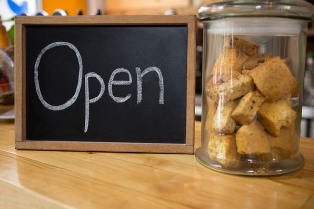 Open sign by cookies in jar on counter - Download Free Stock Photos Pikwizard.com