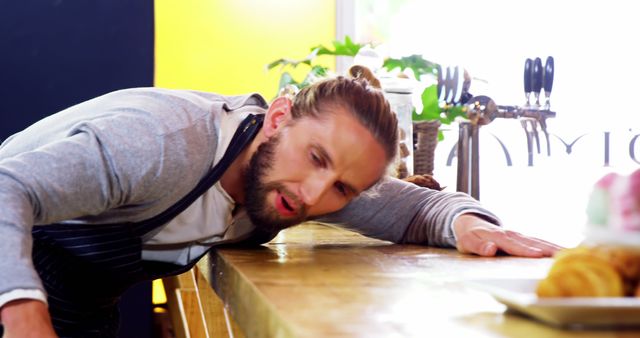 Tired Male Barista Resting in Cafe Kitchen After Long Day - Download Free Stock Images Pikwizard.com