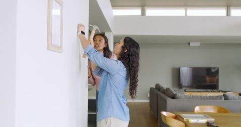 Friends collaborating on home decor project in modern living room