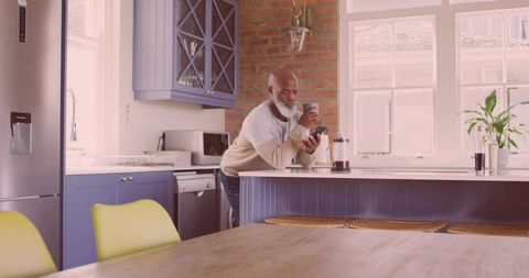 Senior Man Enjoying Coffee in Modern Kitchen