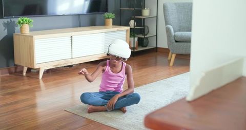 African american teen girl playing with vr headset at home minimalist living room gaming