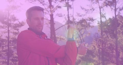 Male hiker stretching arm in forest playfully textured by sunlight