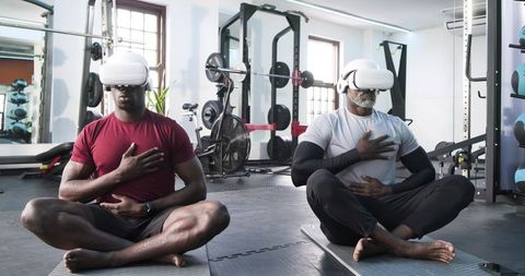 Father and Son Meditate with VR Headsets in Gym for Mindful Workout