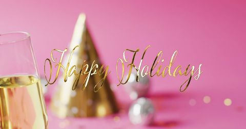 Festive happy holidays greeting with champagne and party hat