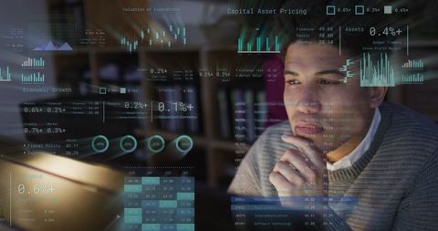 Businessman analyzing digital financial data at desk