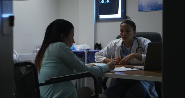 Female Doctor Consulting Wheelchair User in Medical Office - Download Free Stock Images Pikwizard.com