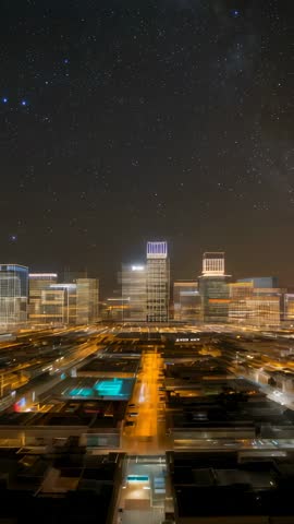 Vertical Night Zoom Revealing Starry Skyline Over Modern Rooftops | Urban Timelapse Video