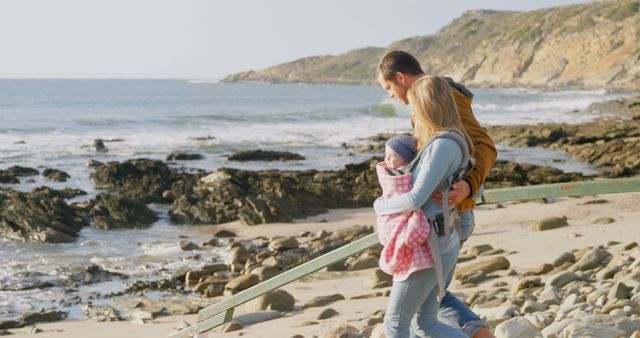 Happy Family Strolling Along Rocky Beach with Baby - Download Free Stock Images Pikwizard.com