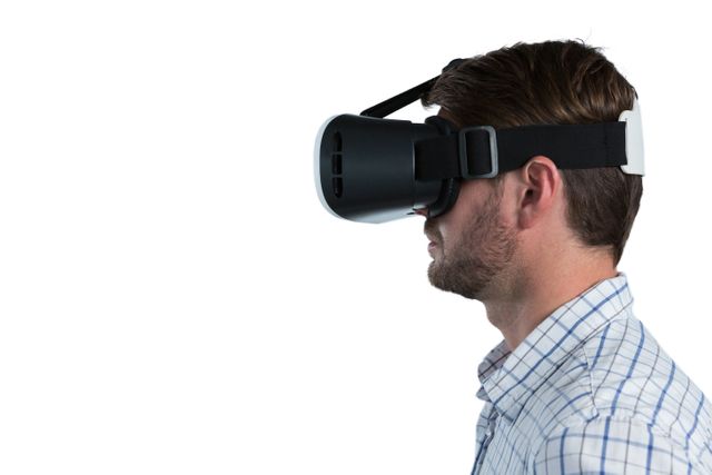 Man wearing virtual reality headset, experiencing immersive technology. Ideal for use in articles or advertisements about VR technology, gaming, tech innovations, and modern gadgets.