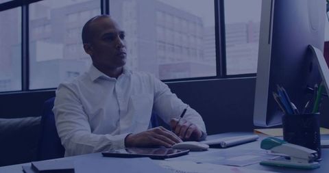 Business professional analyzing reports at corporate office desk