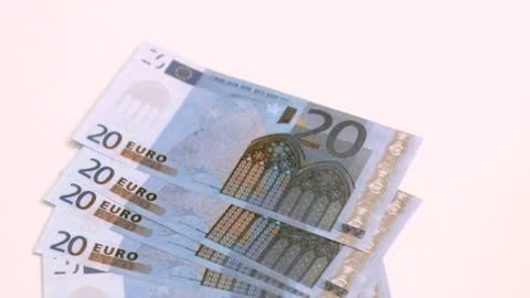 Twenty Euro Banknotes in Slow Motion on White Background