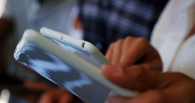 Close-up of hands holding and using smartphones during a social event. This image illustrates social interaction through technology and modern communication methods. Ideal for promoting tech services, mobile applications, or articles on social connectivity.