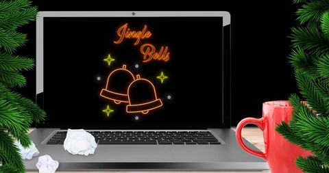Festive laptop with jingle bells neon text for christmas