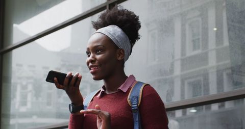 Young Woman Talking on Smartphone Outdoors in Urban Setting