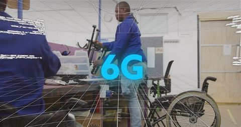 6g lab technician assembling wireless prototype in accessible workshop with wheelchair