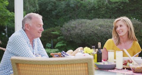 Senior Couple Enjoying Outdoor Family Meal in Sunny Garden - Download Free Stock Images Pikwizard.com