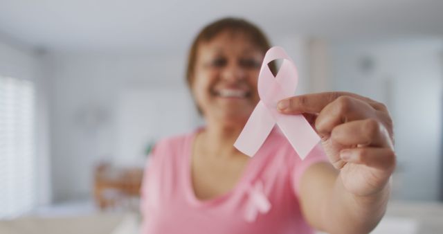 Smiling Woman Holding Pink Ribbon Promoting Breast Cancer Awareness - Download Free Stock Images Pikwizard.com