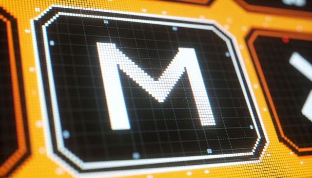 Glowing m glyph on orange tech interface closeup showing pixel grid and octagonal tile