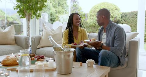 Couple Sharing Dessert in Cozy Living Room Setting