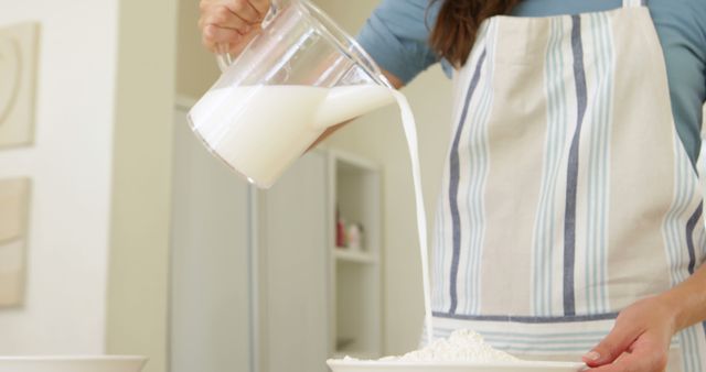 Woman Pouring Milk into Flour Batter Cooking Baking Preparation - Download Free Stock Images Pikwizard.com