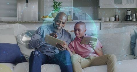 Father teaching teen on couch using tablets with secure cloud network overlay