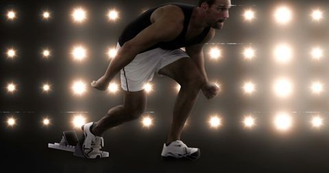 Athlete Dashing Forward Amidst Blazing Lights