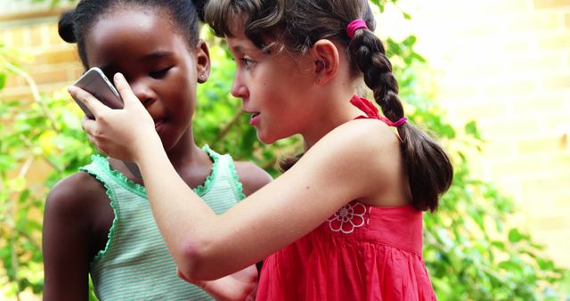 Two Girls Sharing Mobile Phone Outdoors - Download Free Stock Images Pikwizard.com