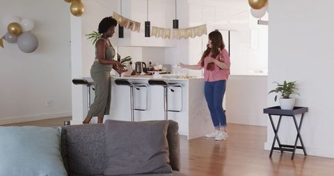 Diverse Lesbian Couple Preparing for Birthday Celebration at Home
