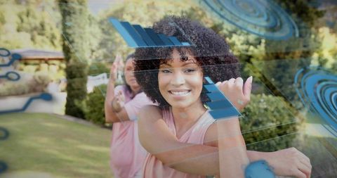 Two women stretching outdoors wearing fitness trackers interacting with ar hud