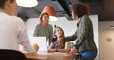 Diverse Female Professionals Collaborating in Modern Office Meeting