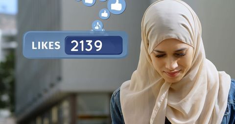Young Muslim Woman Engaging on Social Media with Smartphone